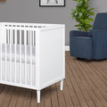 632-WHT Lucas Mini Modern Crib With Rounded Spindles Room Shot 03